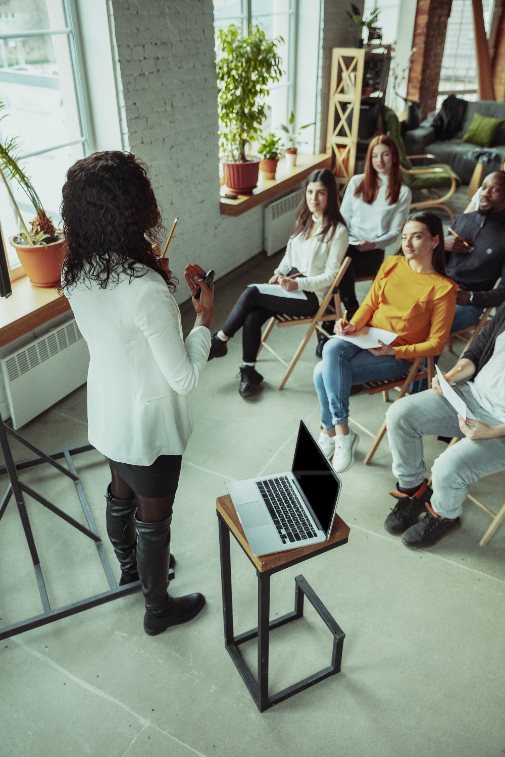 female-african-american-speaker-giving-presentation-hall-university-workshop-1