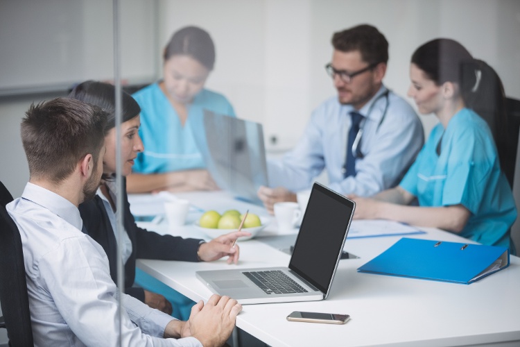 doctors-discussing-laptop-meeting-1